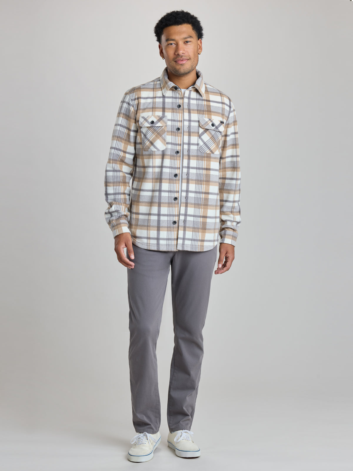 A man modeling a long-sleeve plaid button-up shirt in beige, brown, and white, paired with gray trousers and white sneakers, against a light gray studio background. | Steam